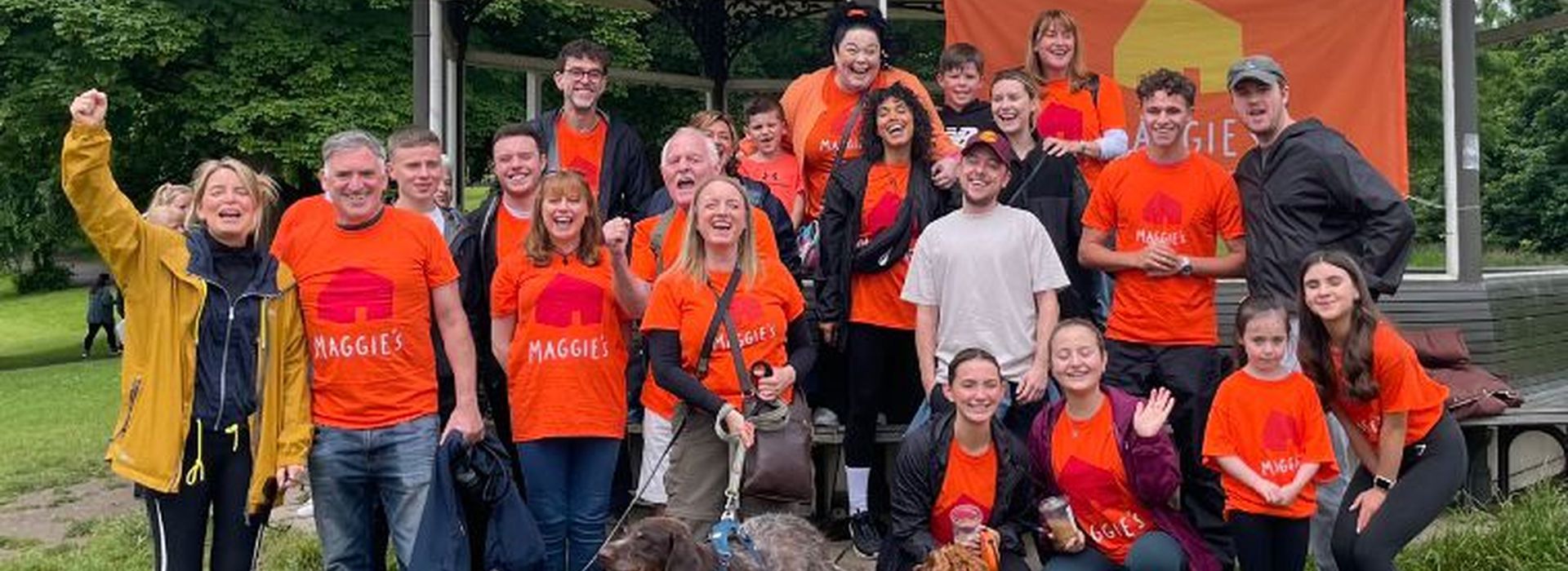 Group photo of cast of Emmerdale wearing orange Maggie's T-shirts after a sponsored walk