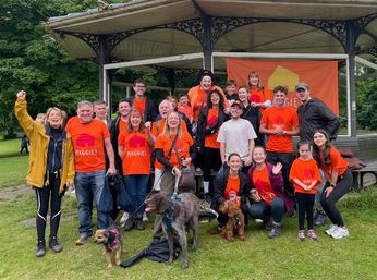 Group photo of cast of Emmerdale wearing orange Maggie's T-shirts after a sponsored walk