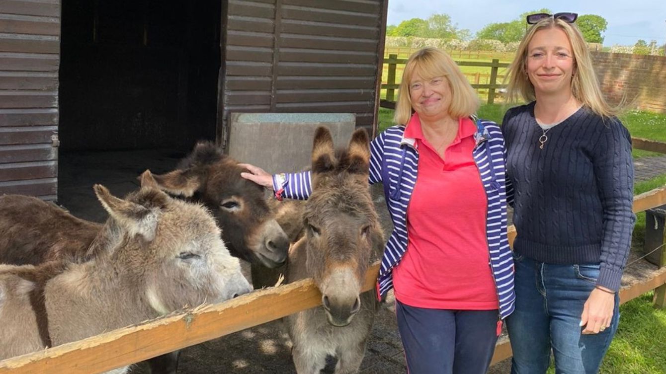 Hannah and her mum at a donkey sanctuary